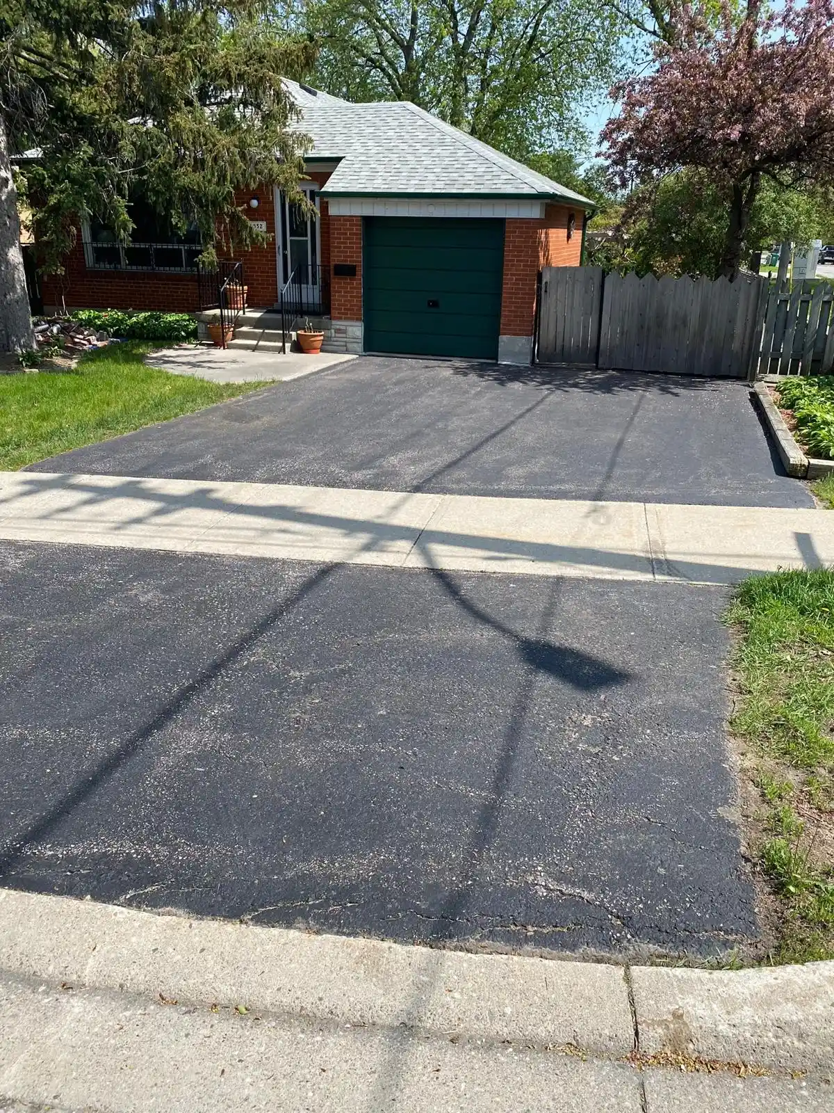New asphalt driveway and walkway